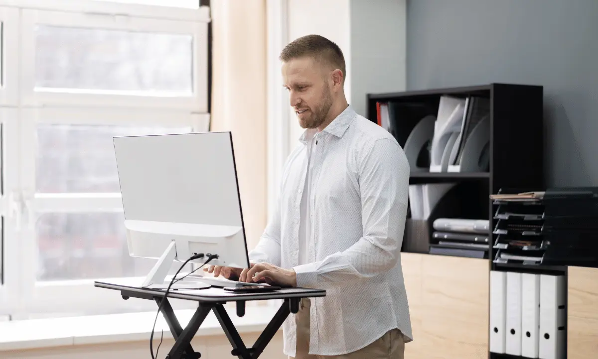 must have gadget verstelbaar bureau waar een man aan werkt